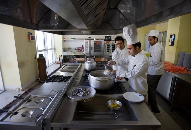 Image: Chefs cook at a kitchen of a five-star hotel in Herat